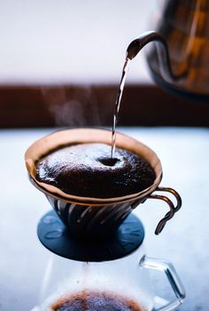 a coffee pot filled with liquid being poured into it