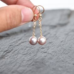 Very pretty light purple/pinkish colored freshwater pearls dangle gently from your choice of sterling silver or gold fill chain and hooks. This material will not tarnish and can even get wet! Pearls are near round and approximately 8mm in size. Very popular and pretty color!! Click here for a complimenting necklace! https://www.etsy.com/listing/613385861/dainty-three-pearl-necklace-with-8mm Rose Gold Dangle Pearl Earrings In Sterling Silver, Dainty Pink Pearl Drop Earrings, Rose Gold Sterling Silver Dangle Pearl Earrings, Pink Dangle Pearl Chain Jewelry, Pink Dainty Dangle Pearl Earrings, Rose Gold Dangle Pearl Earrings, Three Pearl Necklace, Pearl Bangle, Purple Pearl