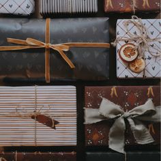 several wrapped presents with ribbons and oranges on them are arranged in a grid pattern