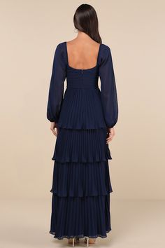 Let everyone be impressed by your stunning style in the Lulus Impactful Elegance Navy Blue Tiered Balloon Sleeve Maxi Dress! Airy, lightweight woven fabric shapes this gorgeous dress that has long balloon sleeves with elastic at the cuffs and shoulders. Sweetheart neckline tops a pleated bodice with a ruched detail at the front and a fitted waist. Accordion-pleated skirt falls in graceful tiers to a maxi hem. Hidden zipper/clasp at back. Fit: This garment fits true to size. Length: Floor length. Flowy Blue Dress With Elastic Sleeves, Blue Flowy Dress With Elastic Sleeves, Fitted Maxi Dress With Lantern Sleeves For Party, Elegant Blue Lantern Sleeve Dress, Bishop Sleeve Maxi Dress For Party, Party Maxi Dress With Gathered Bishop Sleeves, Ruched Bishop Sleeve Party Dresses, Party Maxi Dress With Bishop Sleeves, Long Sleeve Chiffon Dress With Gathered Sleeves