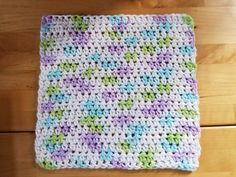 a crocheted dishcloth on a wooden table