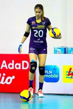 a female volleyball player is about to kick the ball