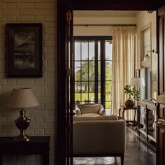 a living room filled with furniture next to a doorway