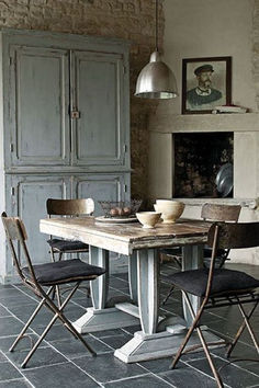 a dining room table with chairs around it and an oven in the backround