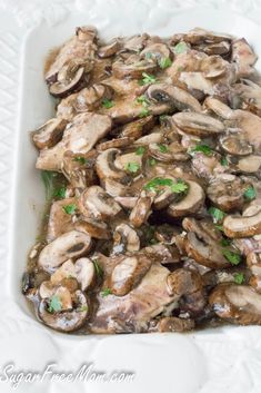 a white plate topped with mushrooms and broccoli