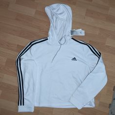 Nwt Adidas Hoodie. Slightly Cropped. Sporty White Top With Drawstring Hood, White Sporty Top With Drawstring Hood, White Long Sleeve Hoodie With Three Stripes, White Three Stripes Sweatshirt Athleisure, White Casual Hoodie With Three Stripes, White Three Stripes Athleisure Sweatshirt, White Three Stripes Sweatshirt In Athleisure Style, Casual Adidas Hoodie With Three Stripes, Adidas White Tops With Ribbed Cuffs