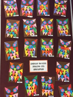 an owl themed bulletin board with lots of colorful paper cut outs on it's sides