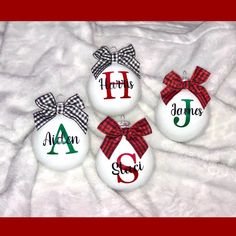 three personalized christmas ornament ornaments with bows and monogrammed letters on them