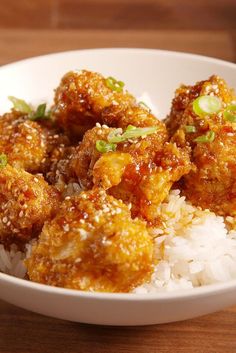 a white bowl filled with rice and meat