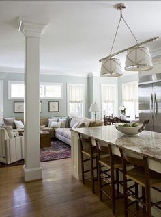 a large kitchen with an island in front of the stove and refrigerator, along with seating for four