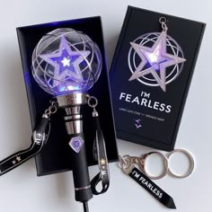 a pair of scissors and a light up pen in a box with the words i'm fearless on it