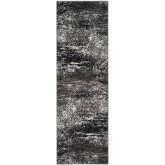 a black and white rug with an abstract design on the bottom, in front of a white background