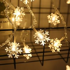 snowflake lights are hanging from a wire