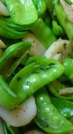 green beans and onions are mixed together in a dish