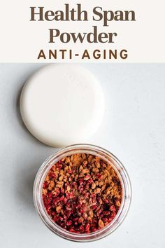 a bowl filled with granola next to a jar of powder on top of a table