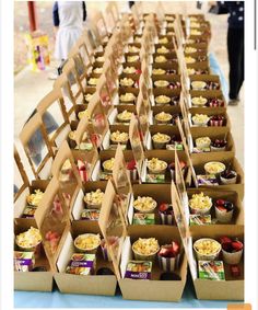 many boxes of food are lined up on a table