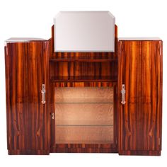 a large wooden cabinet with mirrored doors and drawers