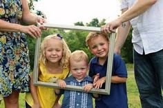 a group of people holding up a picture frame