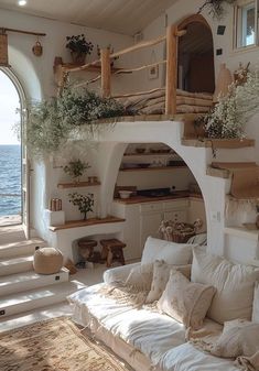 a living room filled with lots of furniture next to an ocean side wall mounted shelf