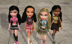 four dolls are standing next to each other on the sidewalk in front of a building