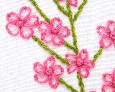 a close up of some pink flowers on a white surface