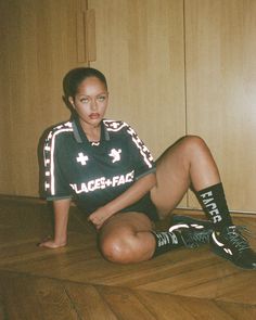 a woman sitting on the floor with her legs crossed