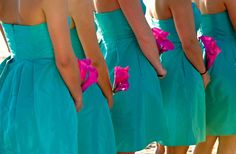 the bridesmaids are wearing bright blue dresses with pink flowers on their waists