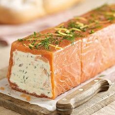 a piece of salmon with cream cheese and herbs on it