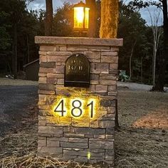 a brick mailbox with a light on it