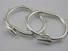 pair of silver hoop earrings on grey background