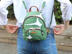 a woman wearing a green and white backpack