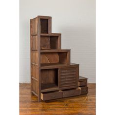 a wooden shelf with drawers on top of it