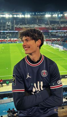 a man standing in front of a soccer field