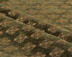 a close up view of a rug with brown and tan designs on it's surface