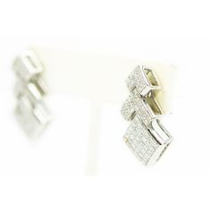 Impressive 1.10" long geometric 18k white gold earrings featuring three sections of invisible set princess cut diamonds. They have post and omega backs. Luxury White Gold Diamond Earrings In Rectangular Shape, Luxury White Gold Diamond Earrings Rectangular, Luxury White Gold Rectangular Diamond Earrings, Modern Diamond Drop Earrings With Single Cut Diamonds, Silver Platinum Earrings With Baguette Diamonds, Luxury Rectangular Diamond Cut Earrings, Rectangular Baguette Diamond Earrings, Formal White Gold Diamond Earrings Rectangular, Formal Rectangular White Gold Diamond Earrings