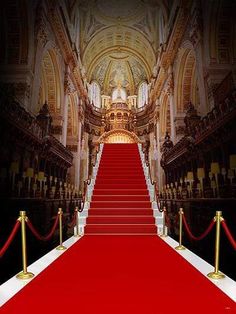 a red carpeted staircase leading up to an ornate building