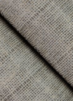 the texture of an upholstered fabric is shown in grey and brown tones,