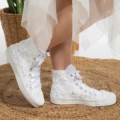 The white upper is adorned with meticulously handcrafted floral lace, and pearls on both sides, adding an elegant touch to every step you take. The satin ribbon laces enhance the glam of these bridal sneakers, making them a perfect choice for any bride who wants to be comfortable and glamorous on her special day. Whether you're looking for a unique way to express your style or simply want to keep your feet comfortable during your wedding reception, these lace wedding trainers are a perfect choice. Canvas decorated with Lace and pearls.