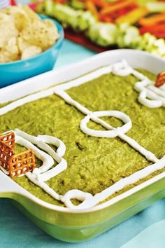 a close up of a tray of food on a table with other foods in the background