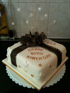 a birthday cake with stars and ribbons on it