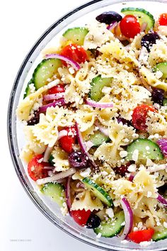 a salad with cucumbers, tomatoes, olives, and feta cheese