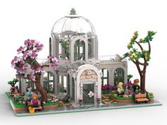 a building made out of legos with trees and flowers on the front, and people inside