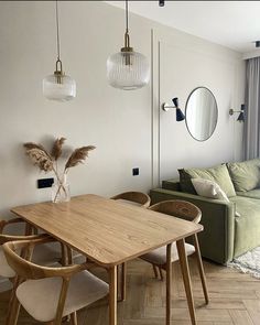 a living room filled with furniture and a wooden table in front of a green couch