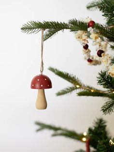 a mushroom ornament hanging from a christmas tree