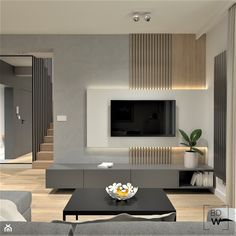 a modern living room with grey furniture and white walls