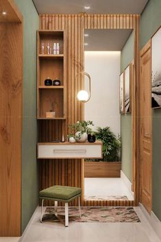 a bathroom with green walls and white flooring, wooden cabinets and a bench in the corner