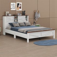 a white bed sitting on top of a wooden floor