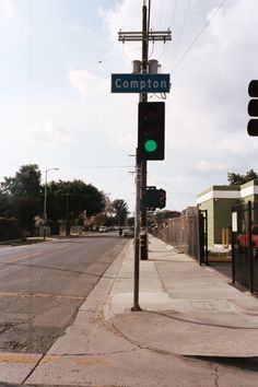 a green traffic light sitting on the side of a road