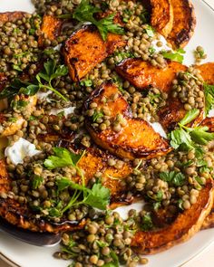 a white plate topped with sweet potatoes and lentils