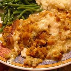 a plate with mashed potatoes, green beans and gravy